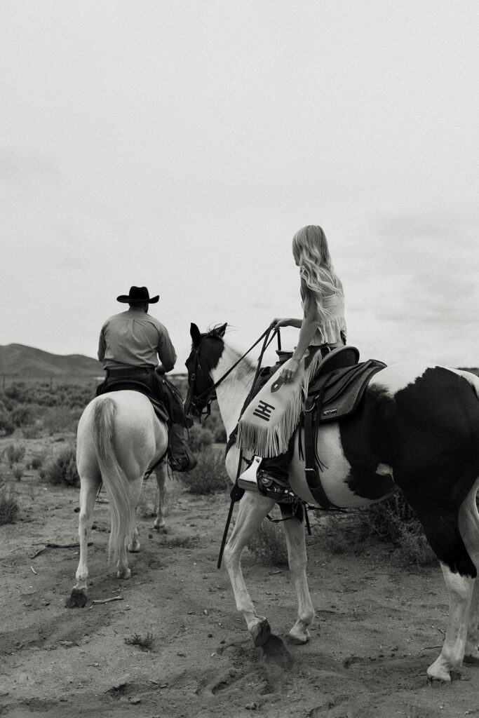 Elrod Ranch | Tyler and Sarah on horses riding in pasture