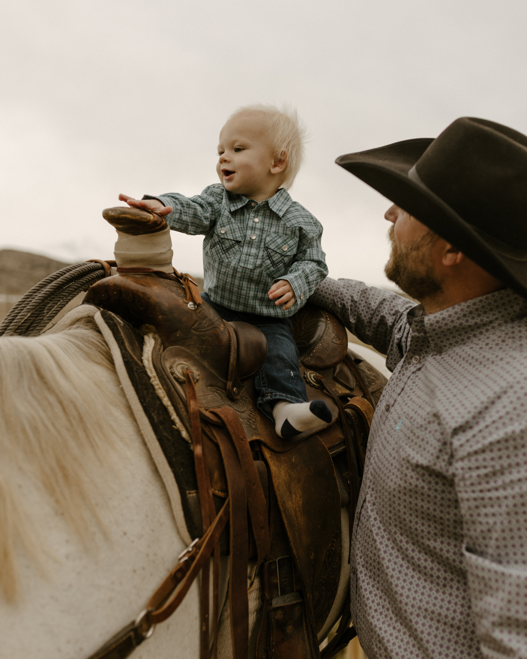 baby boy riding a horse in western attire