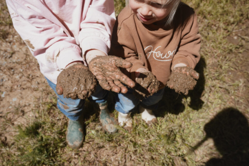 kids with muddy hands, ranch life