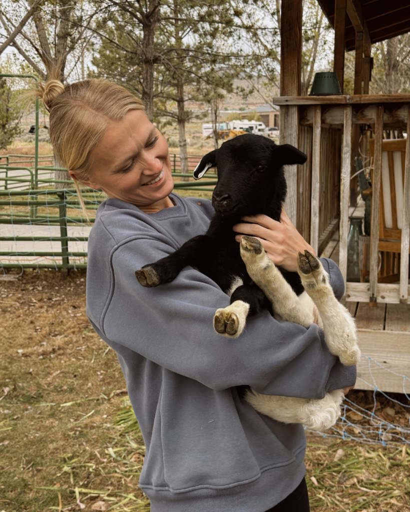Sarah Elrod holding a baby lamb 